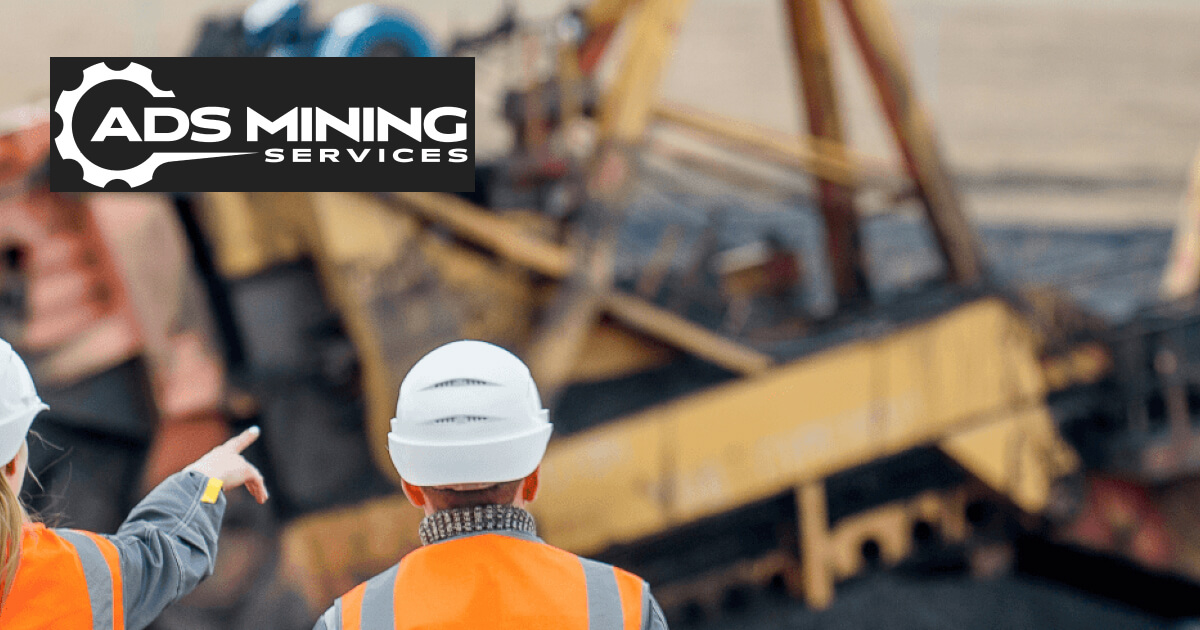 Skilled project management professionals pointing at Heavy duty mining equipment at ADS Mining Services - Underground Coal Mining Operations